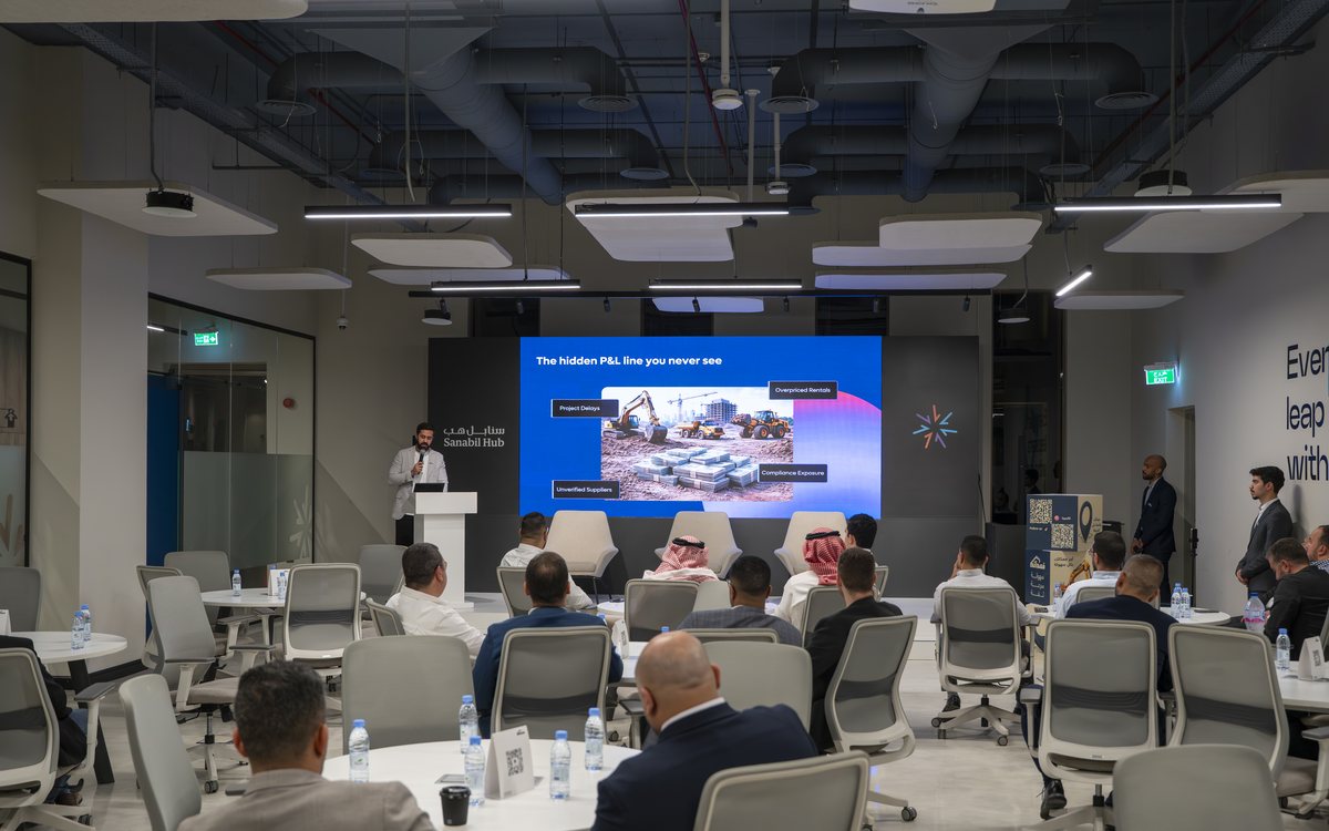 An industry session in progress, attendees seated at round tables facing a presentation screen
