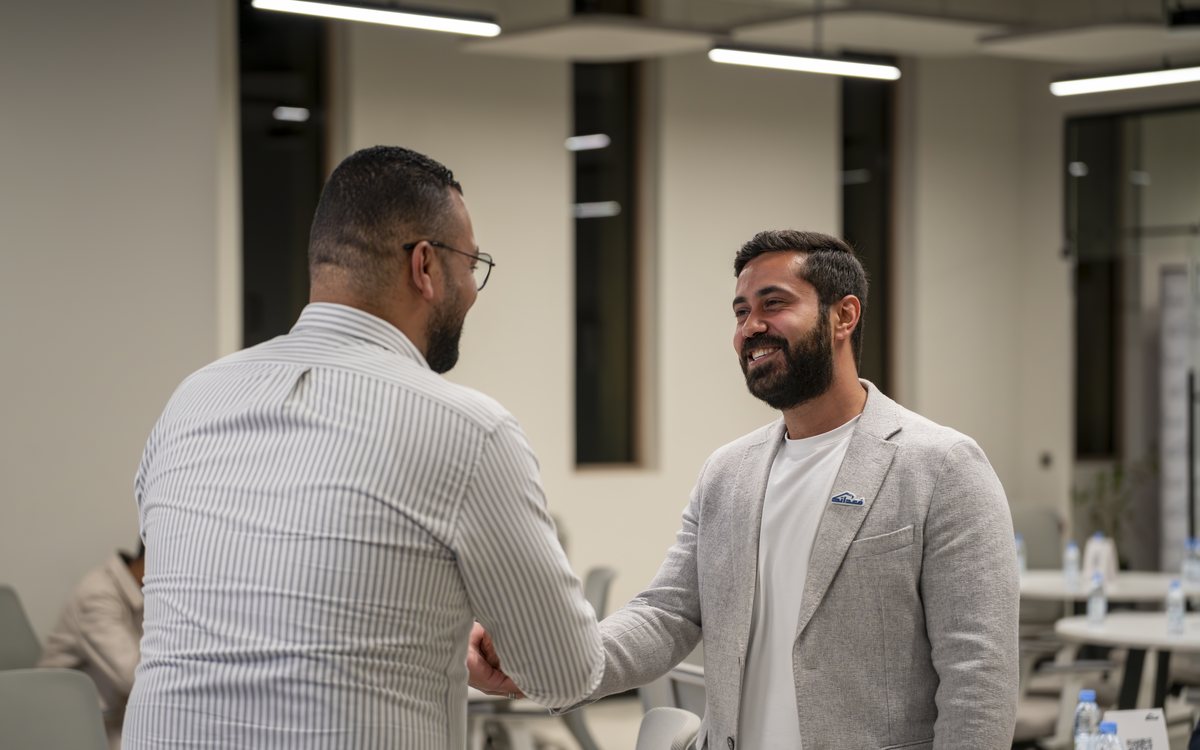 Two people shaking hands in an office